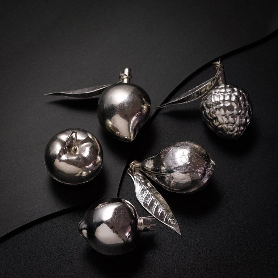 a group of silver ornaments sitting on top of a table