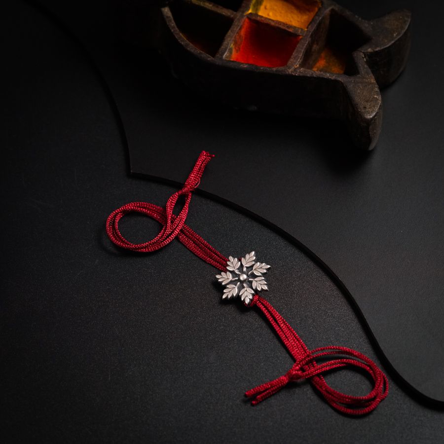 a red cord with a cross on it
