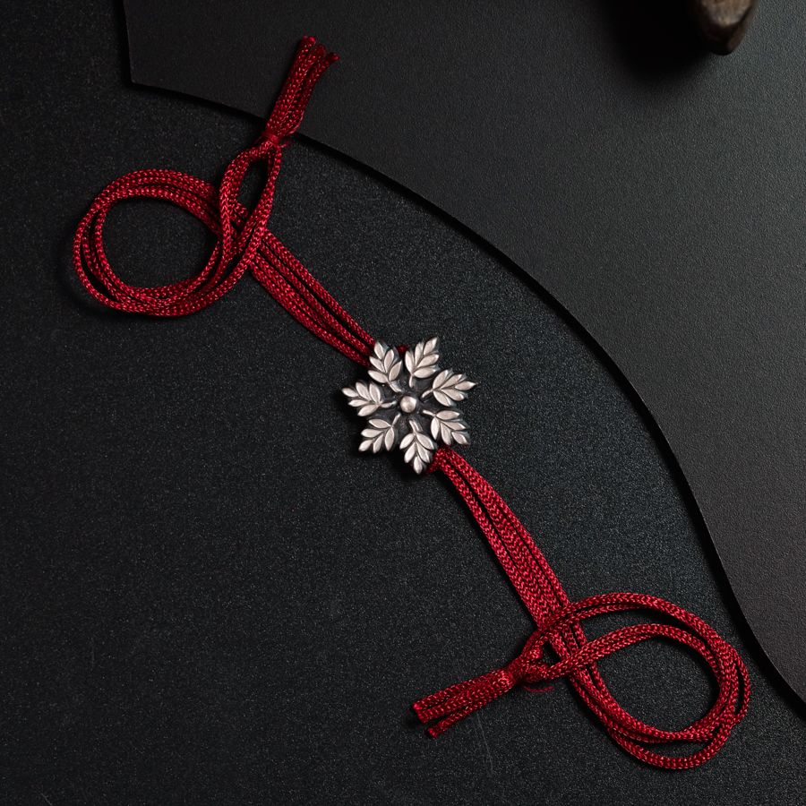 a red ribbon with a snowflake brooch on it