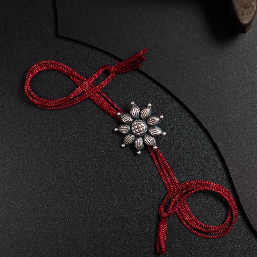 a close up of a red ribbon with a cross on it