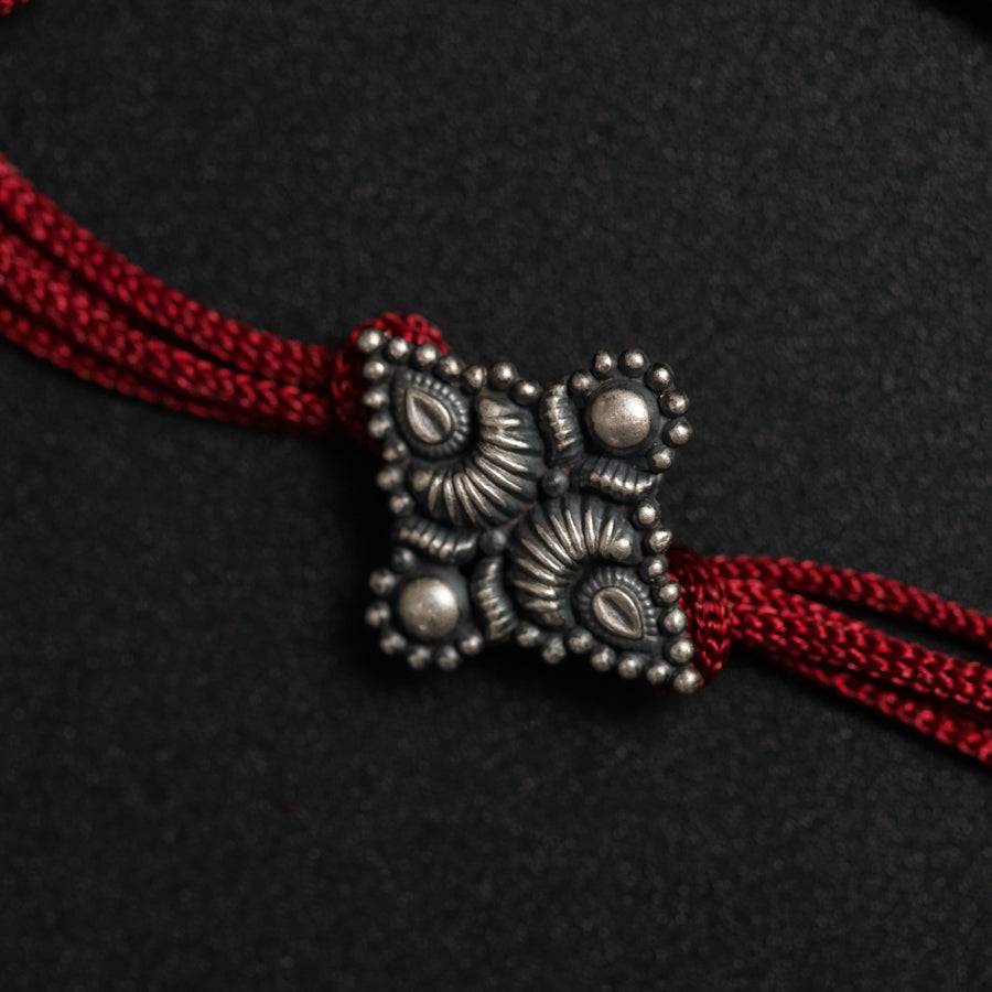 a close up of a red string with beads