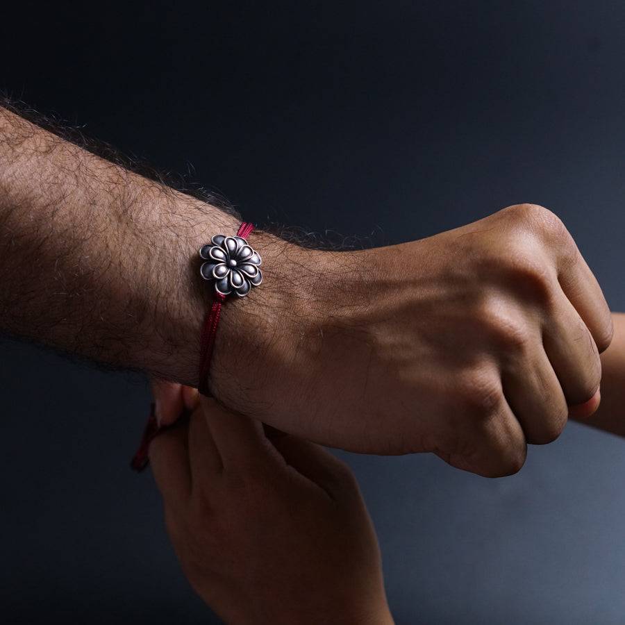 a man holding a woman's hand with a bracelet on it