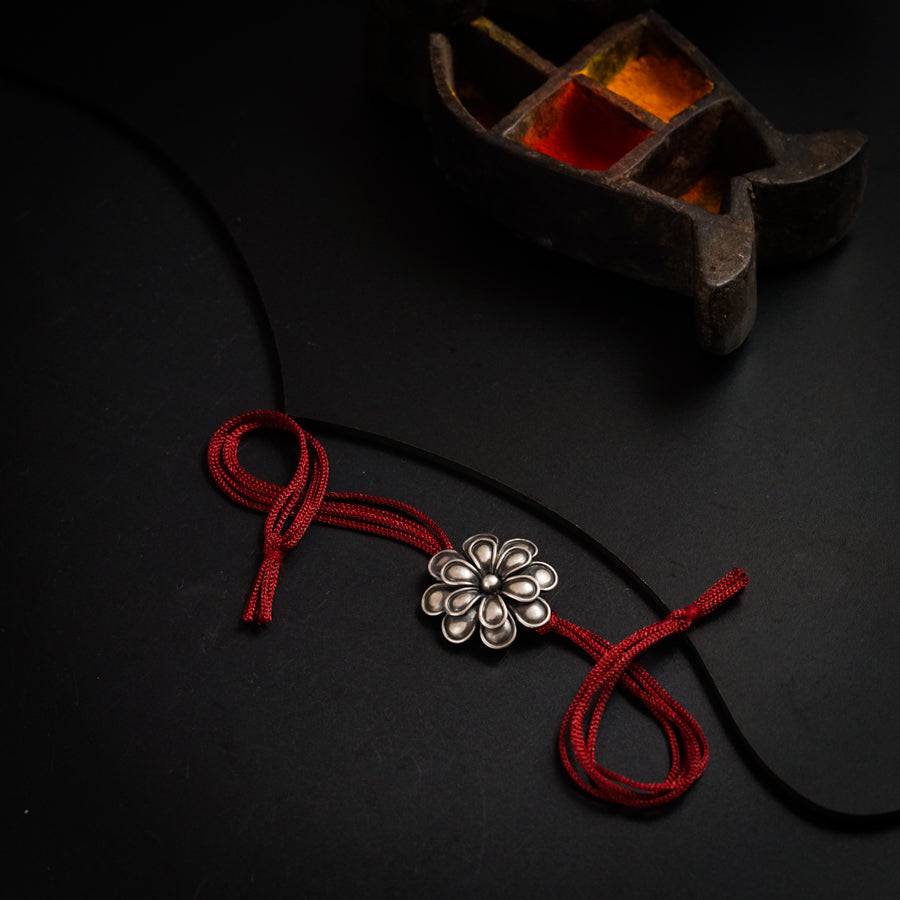 a red string with a flower on it