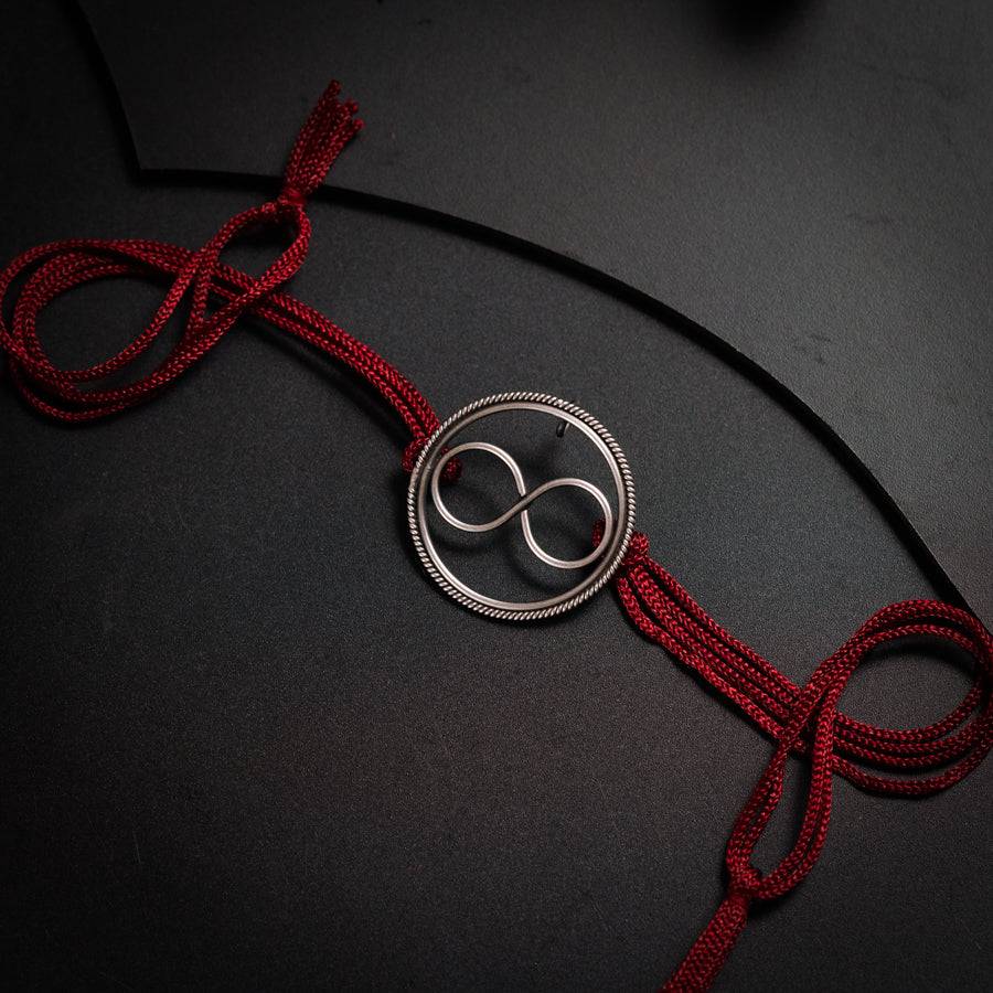a red cord with a button on it