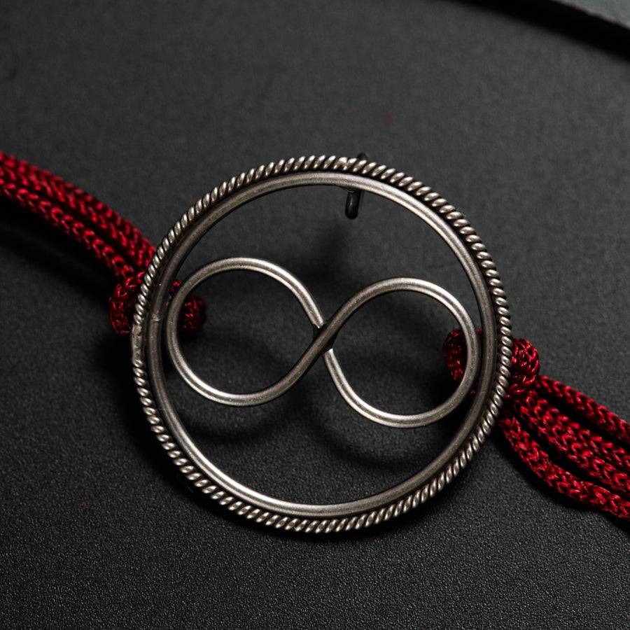 a metal object with a red string around it