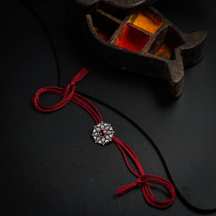 a red string with a flower on it