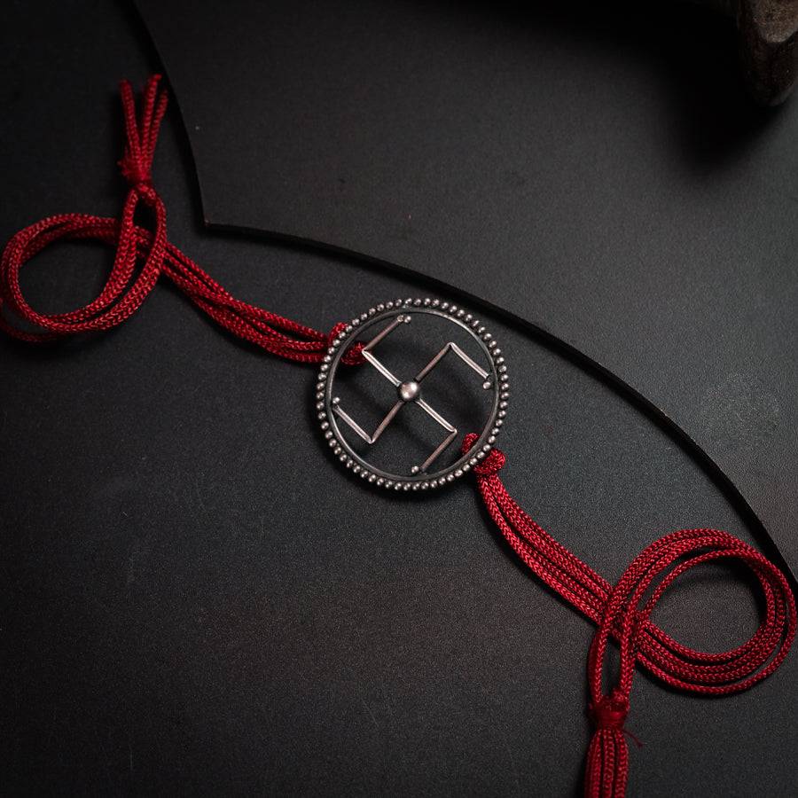 a red cord with a silver buckle on it