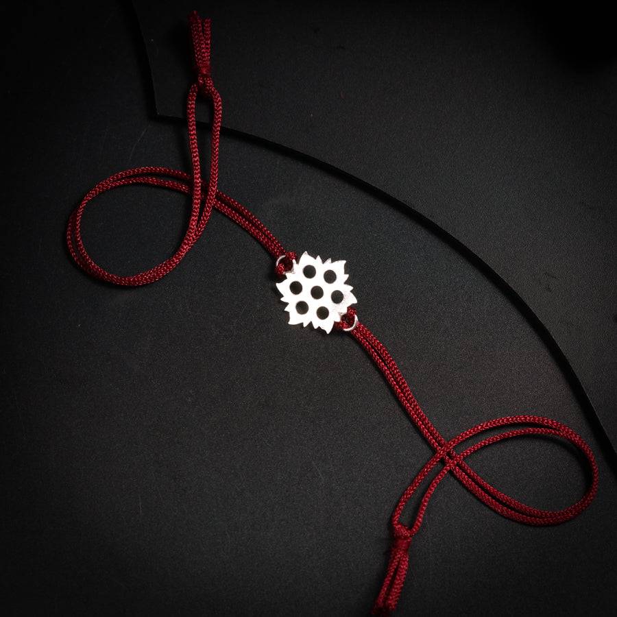 a red cord with a white flower on it