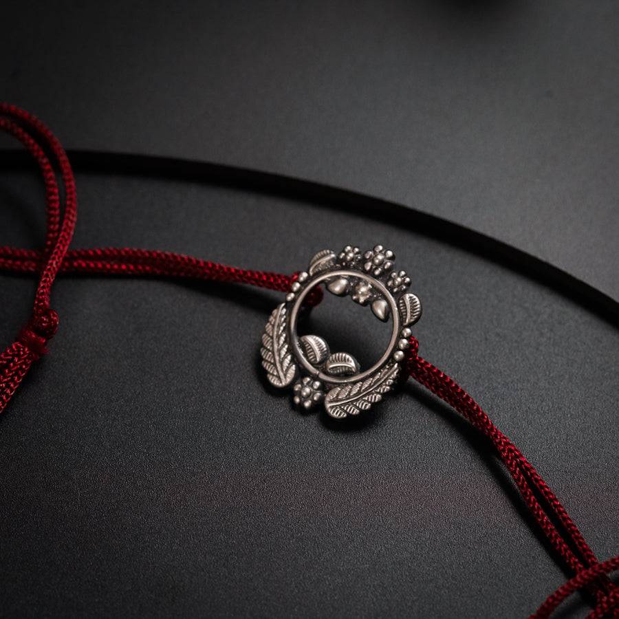 a close up of a red cord with a silver clasp