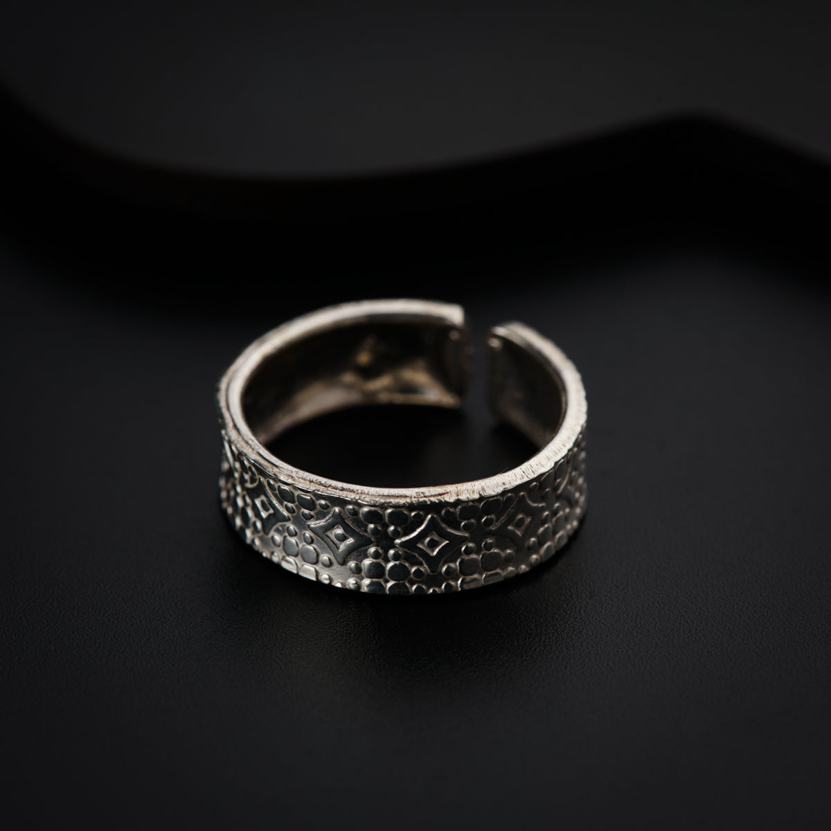 a close up of a ring on a black surface