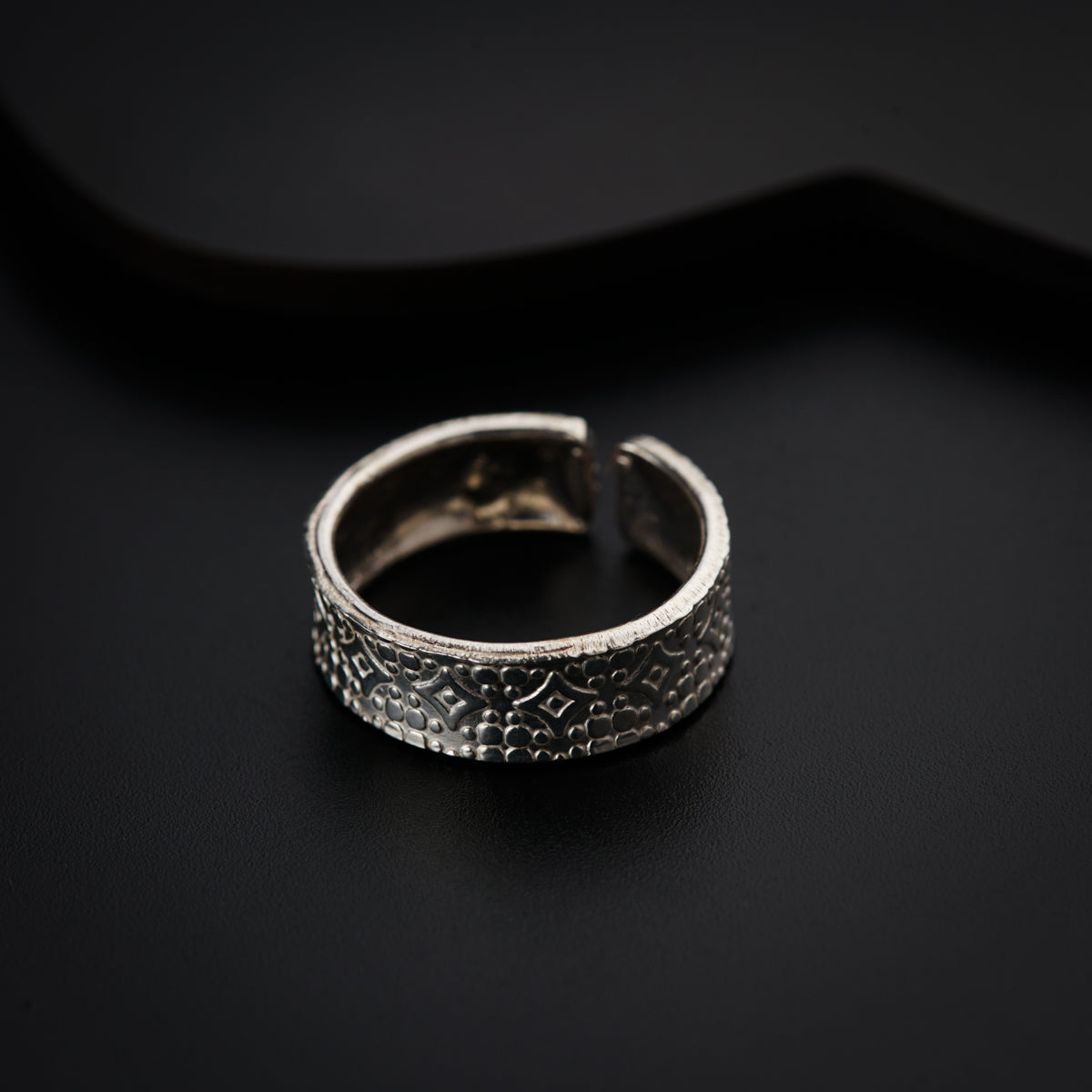 a close up of a ring on a black surface