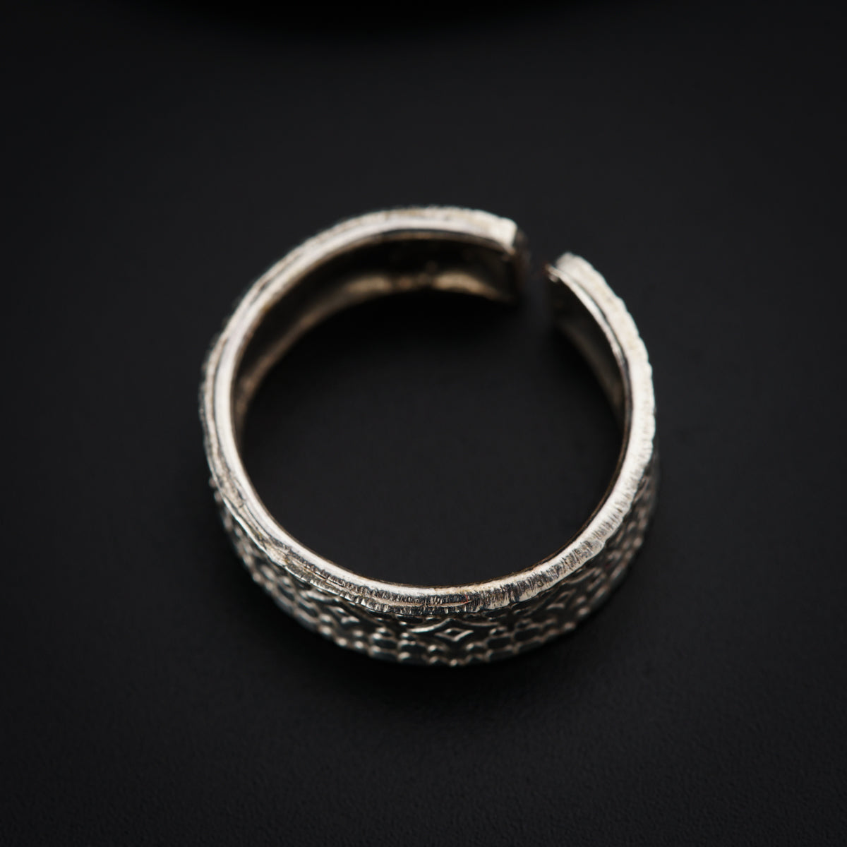 a close up of a ring on a black surface