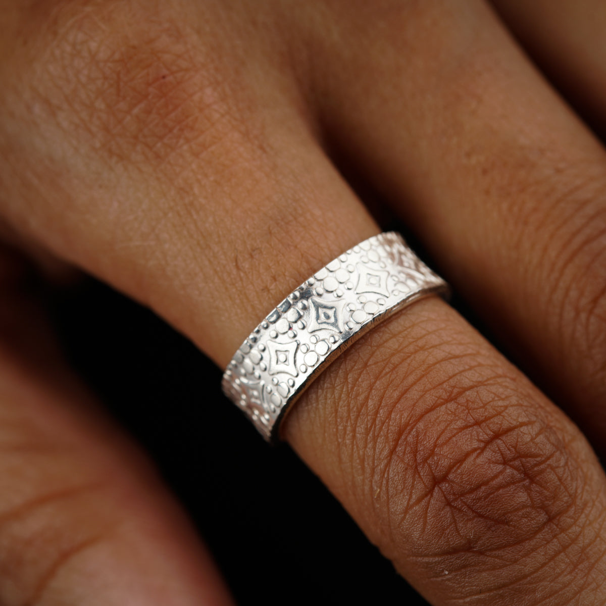 a close up of a person wearing a wedding ring