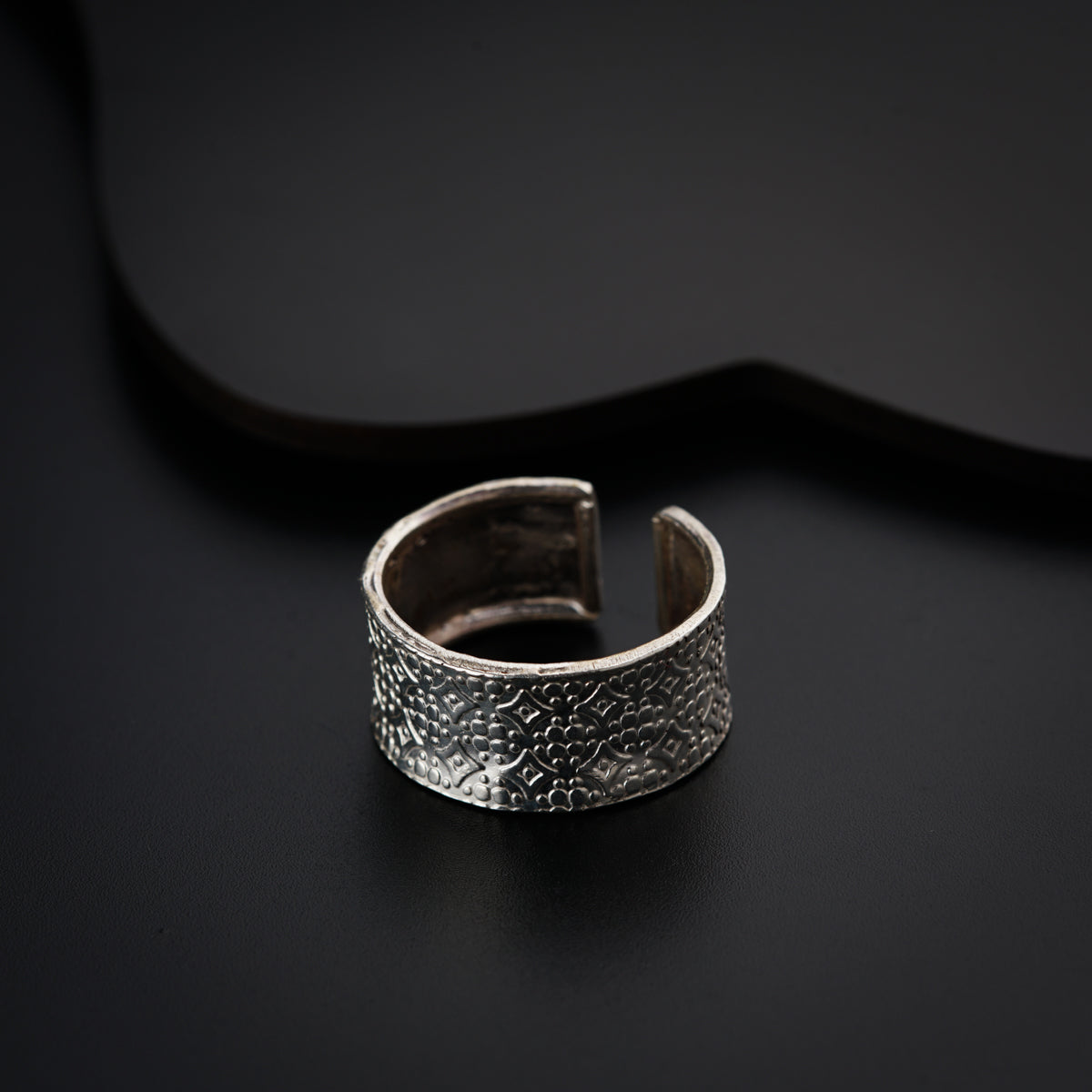 a close up of a ring on a black surface