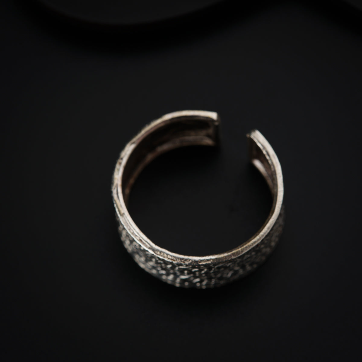 a close up of a ring on a black surface