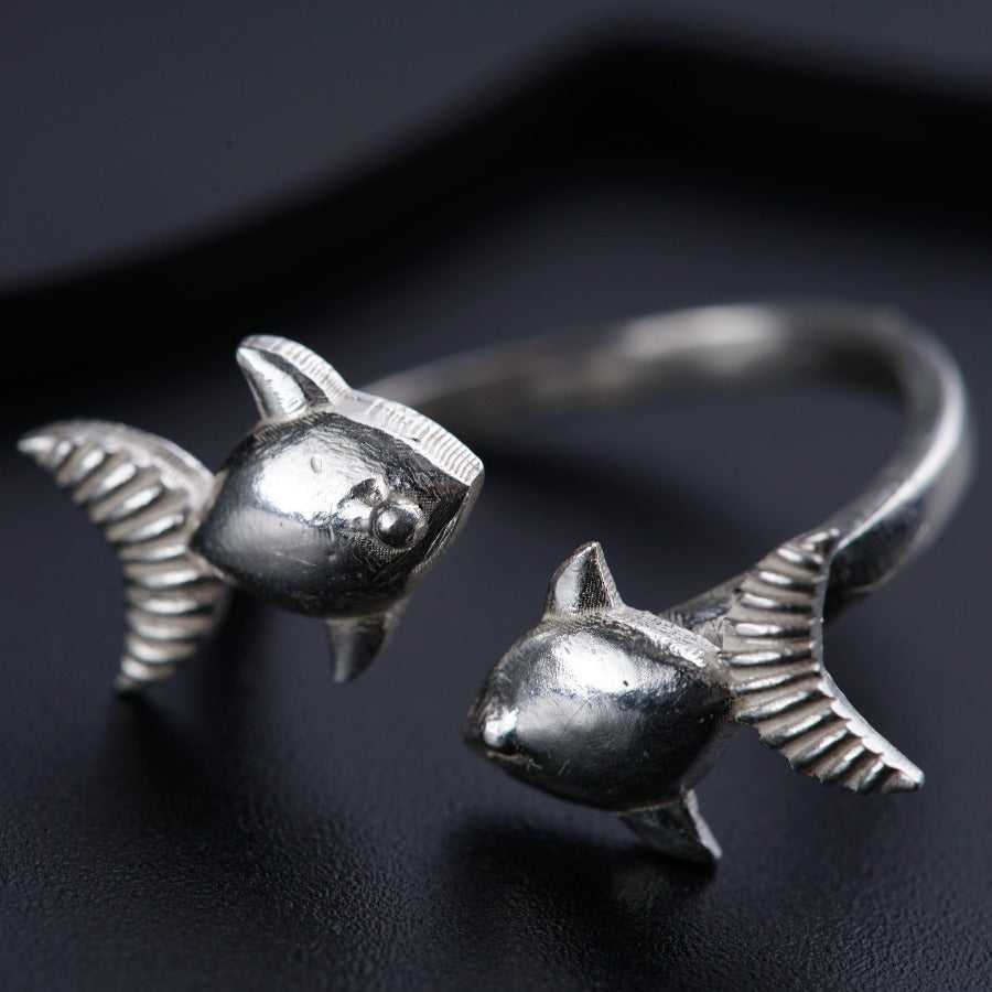 a close up of a ring with a fish on it