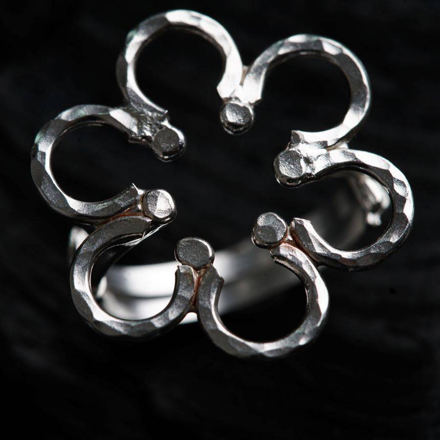 a close up of a silver ring on a black background