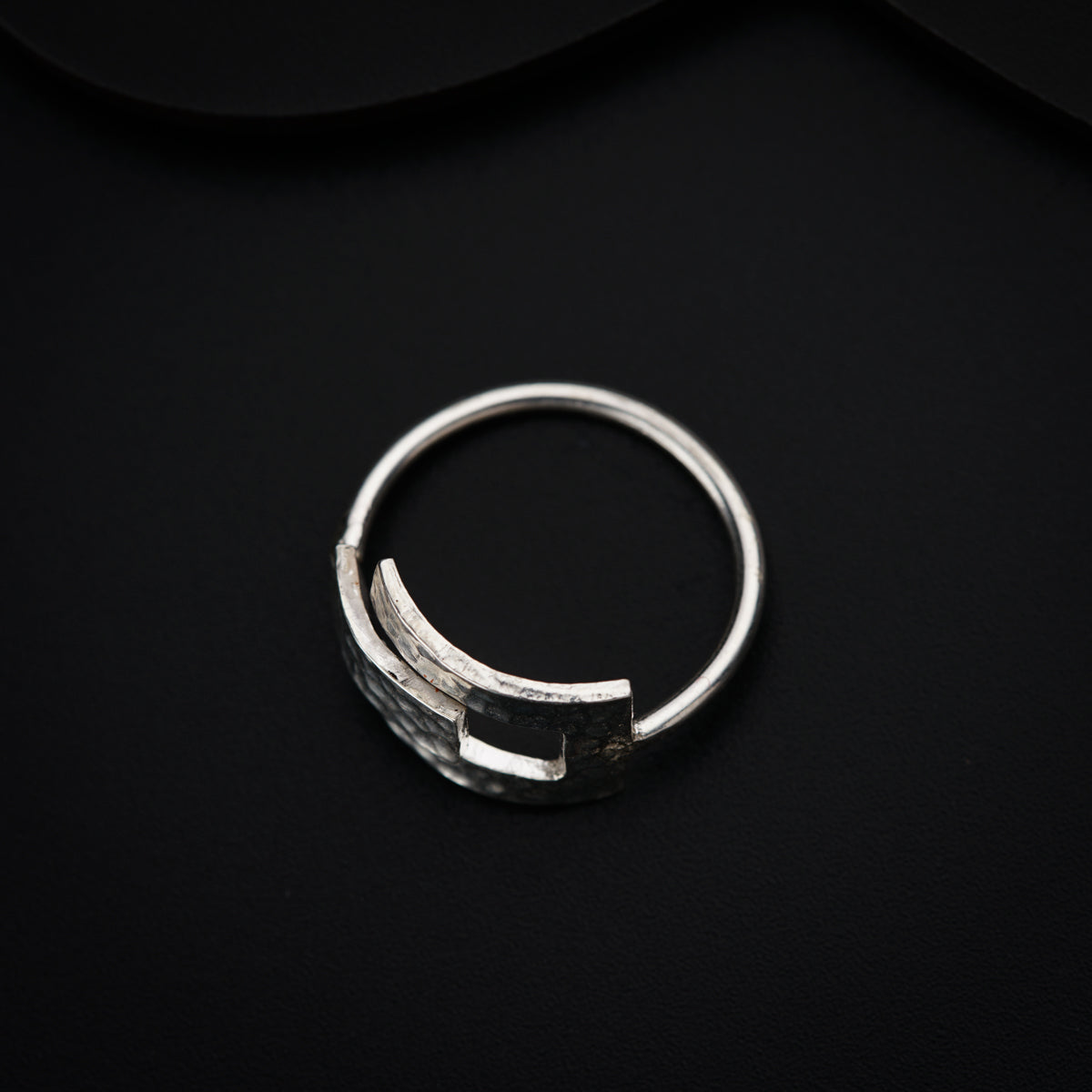 a close up of a ring on a black surface