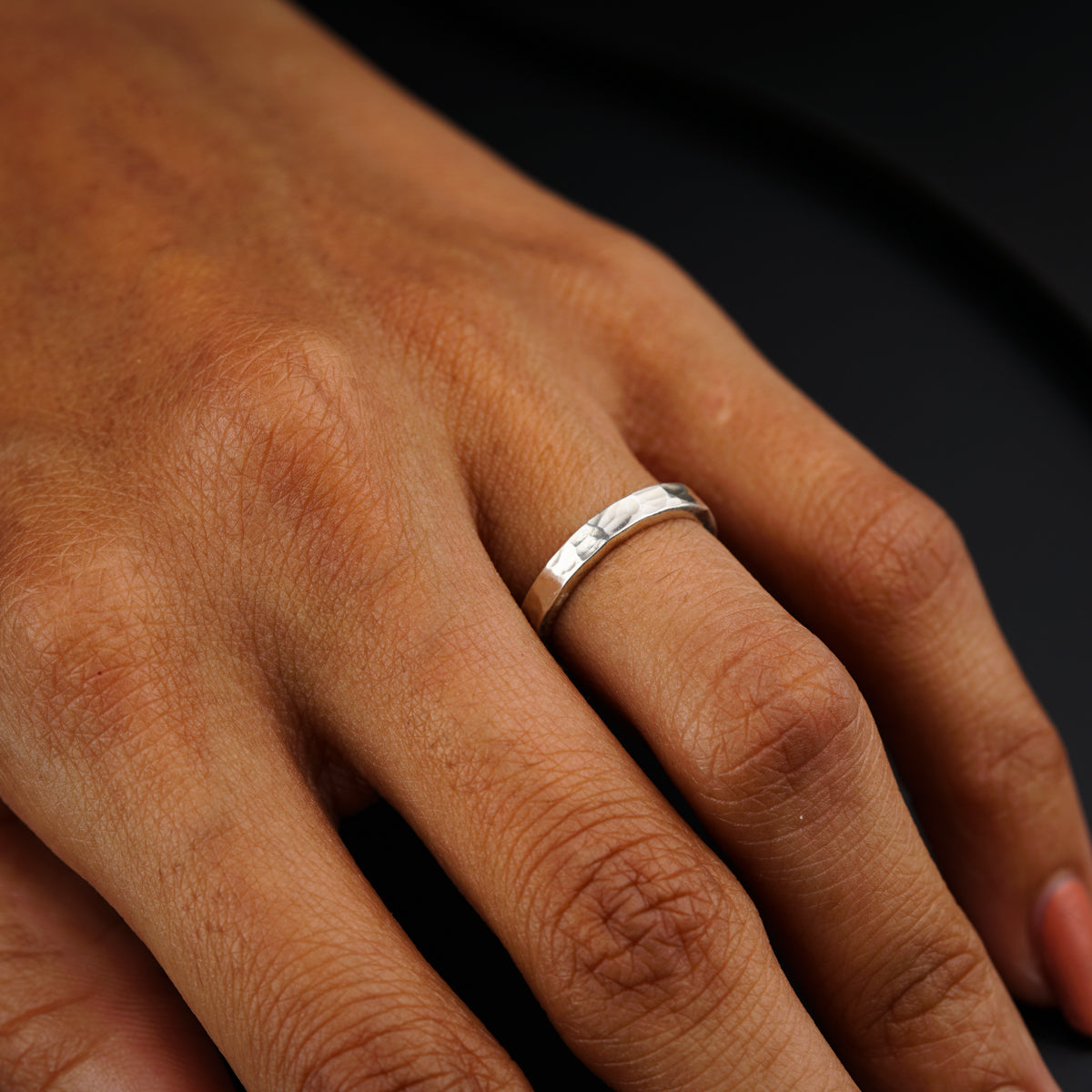 a person's hand with a ring on it