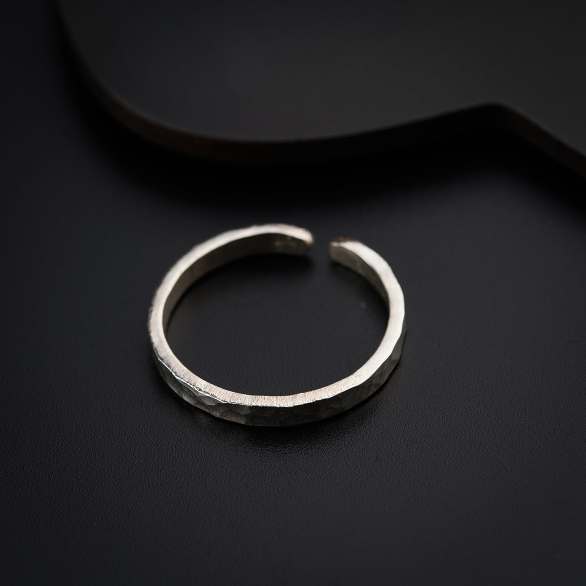 a close up of a ring on a black surface