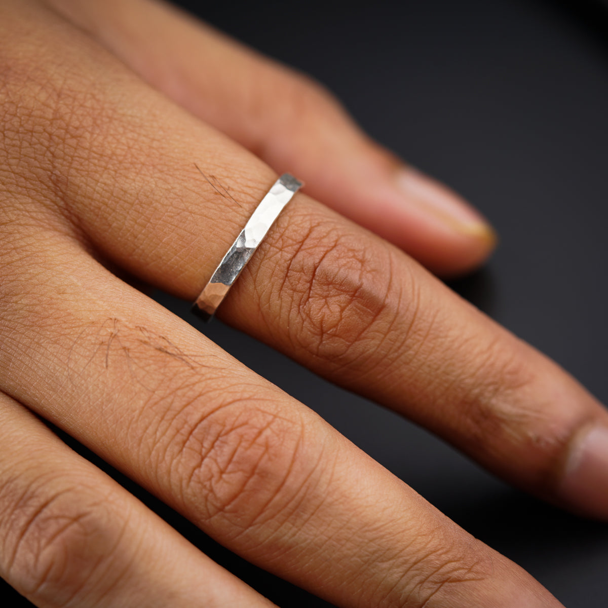 Unisex hammered silver ring on finger