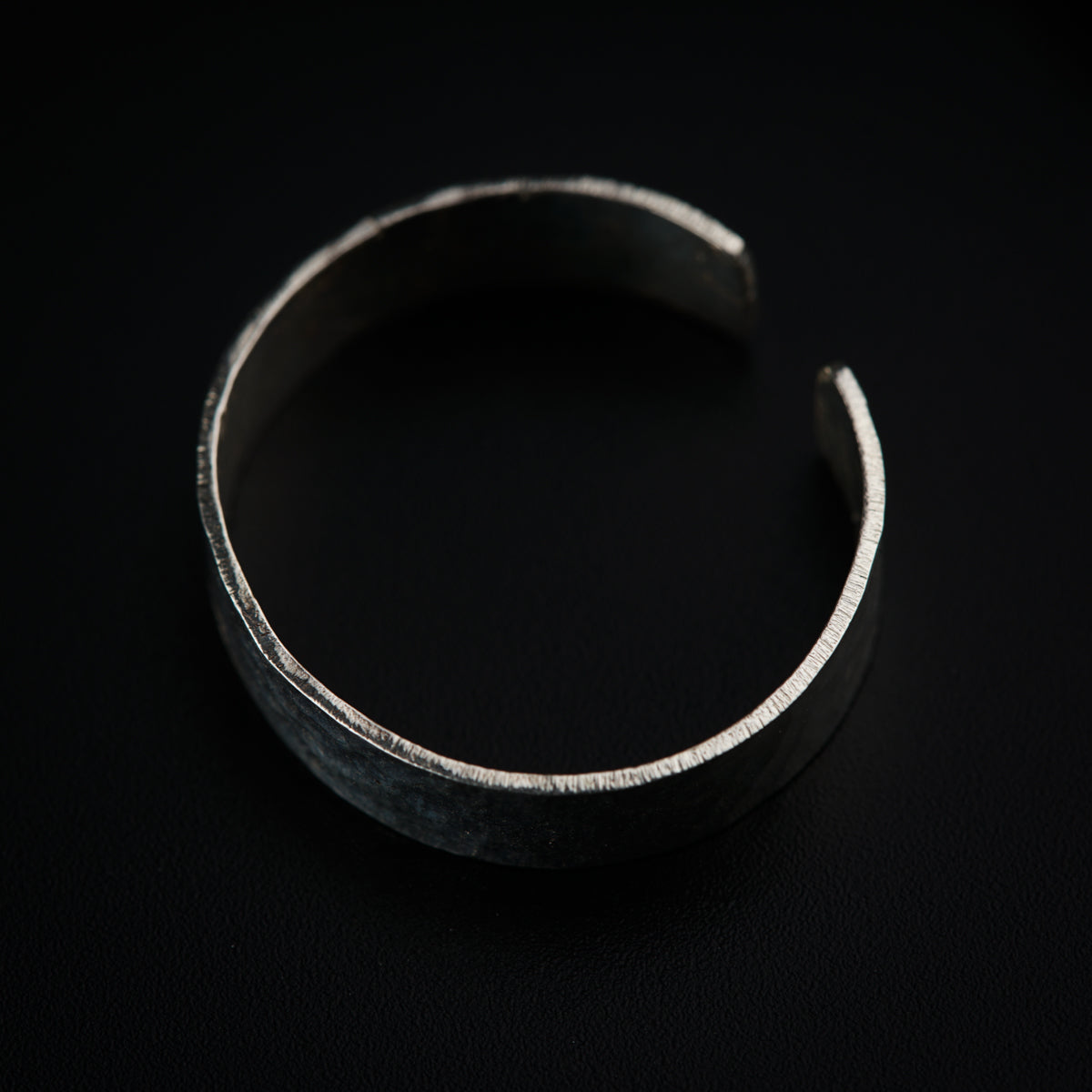 a close up of a metal object on a black surface