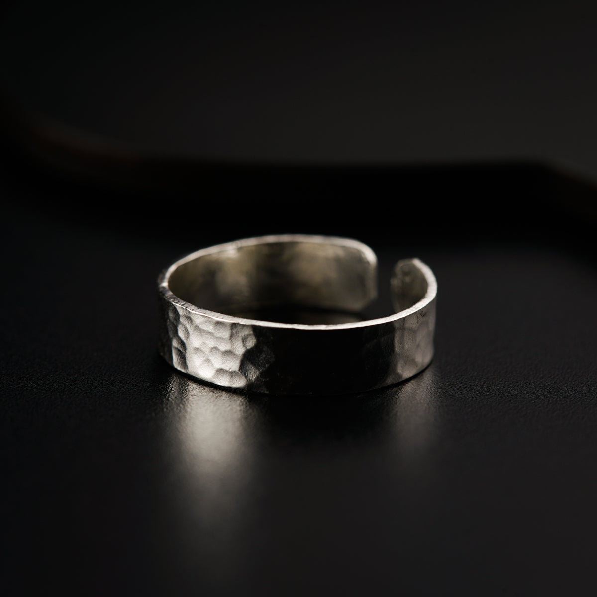 a close up of a silver ring on a table