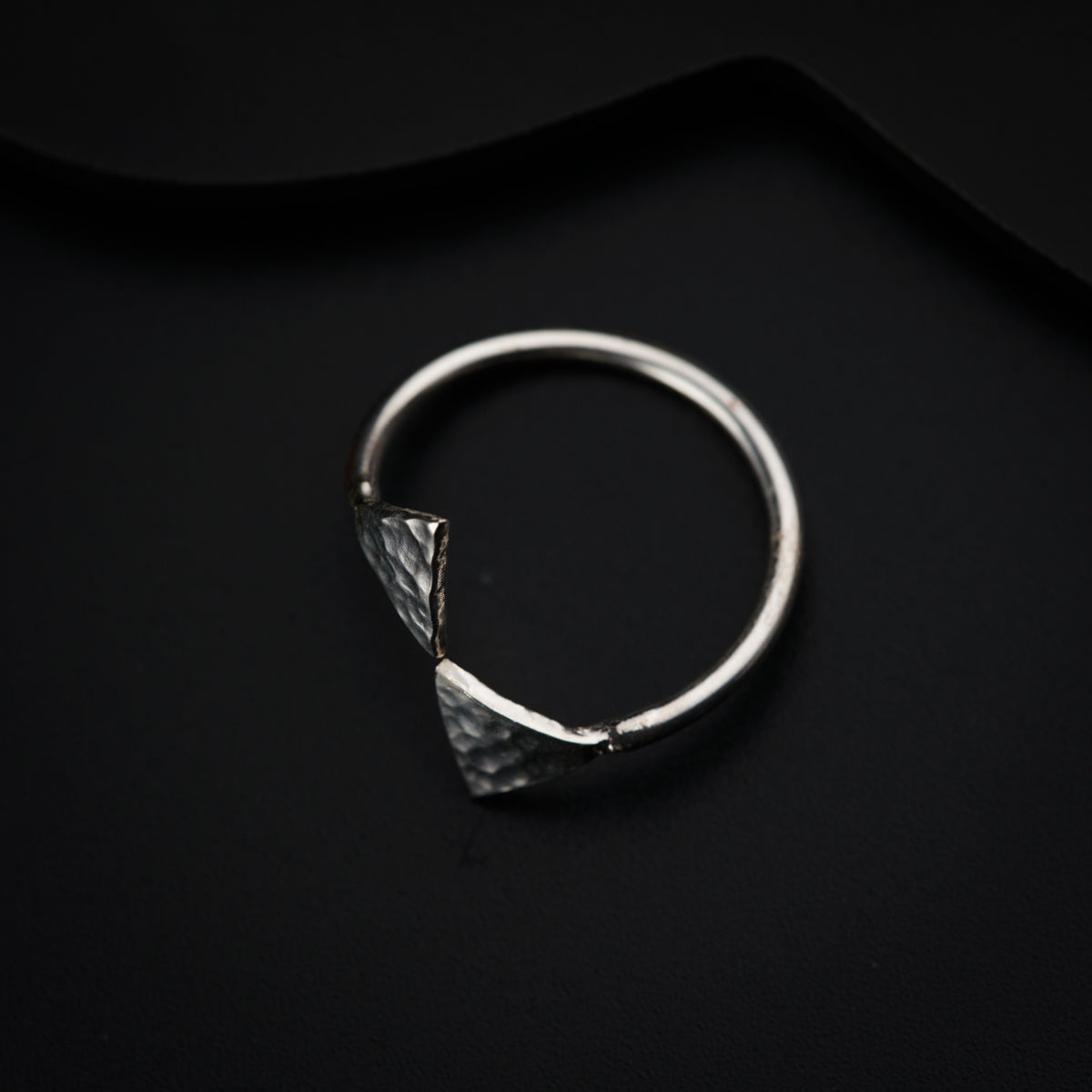 a close up of a ring on a black surface