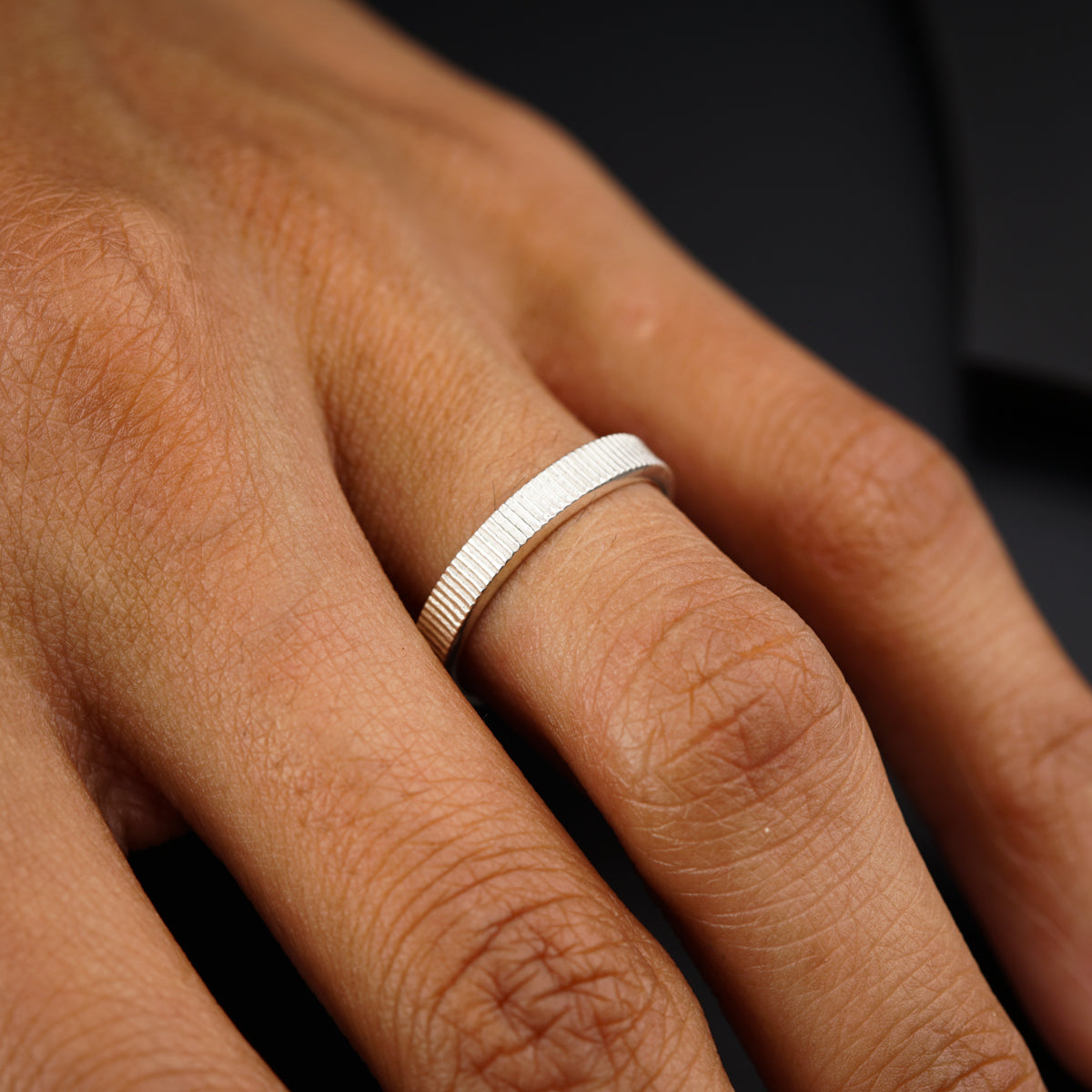 a person's hand with a ring on it