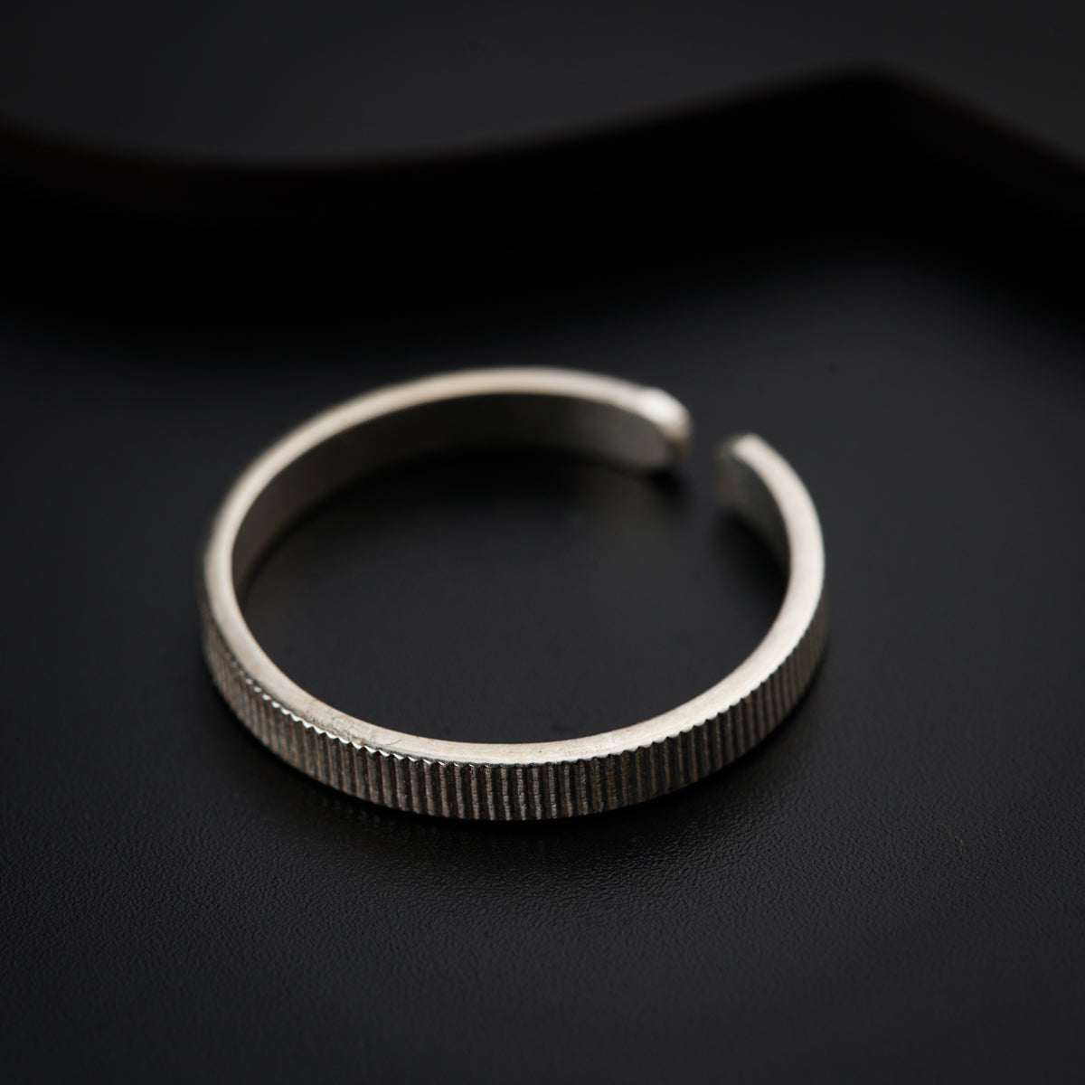 a close up of a ring on a black surface