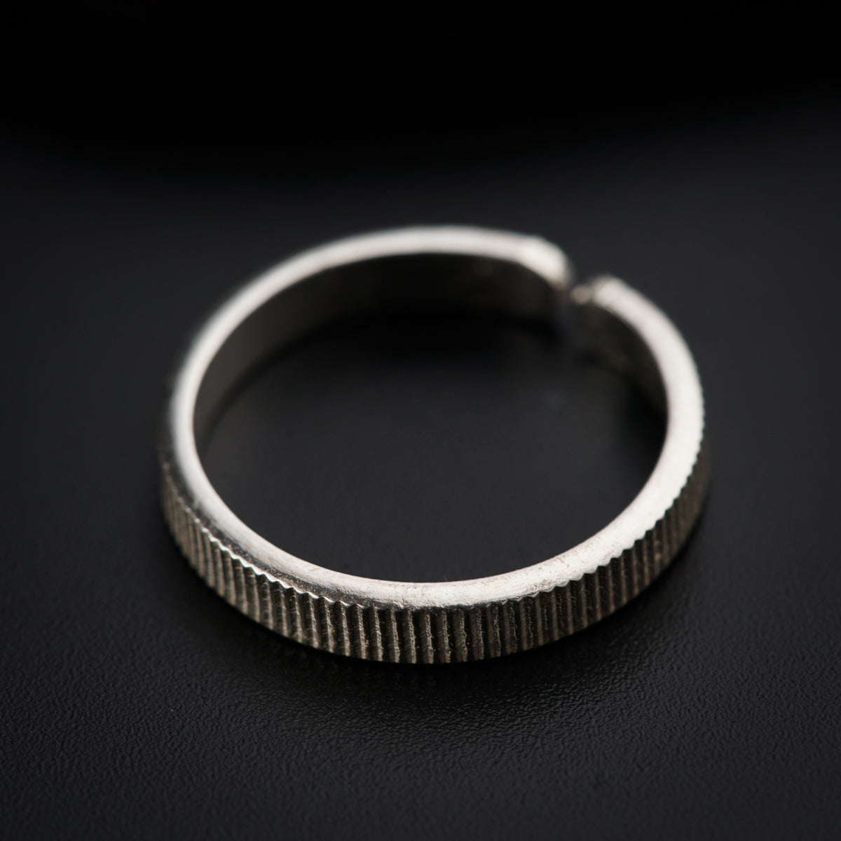 a close up of a ring on a black surface