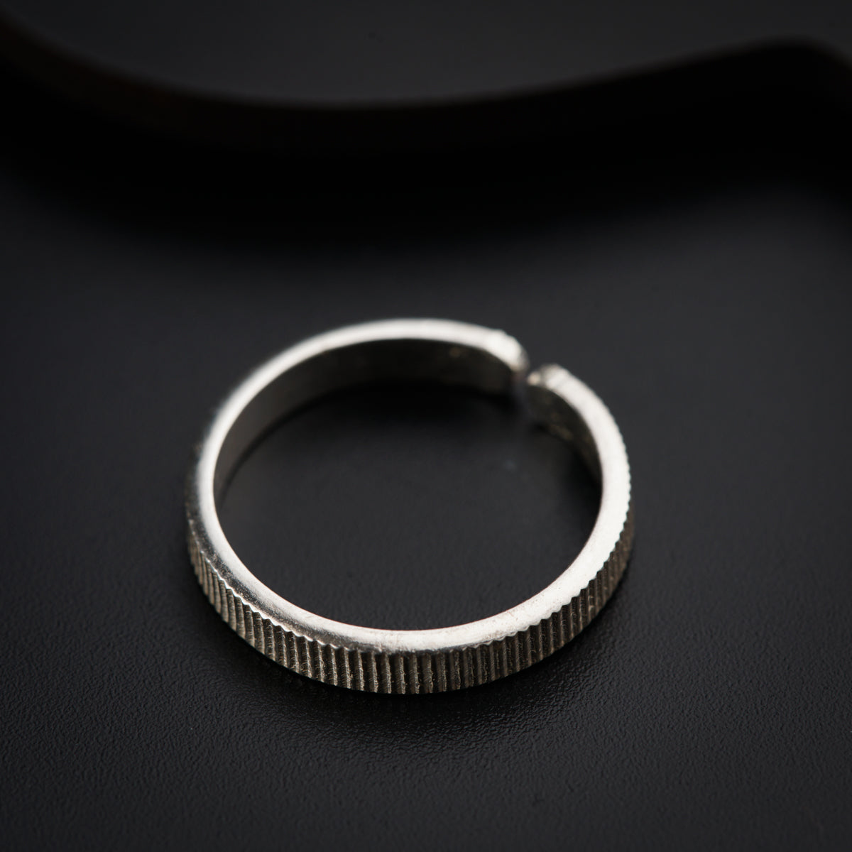 a close up of a ring on a black surface