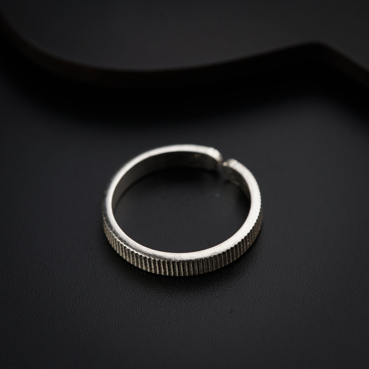 a close up of a ring on a black surface
