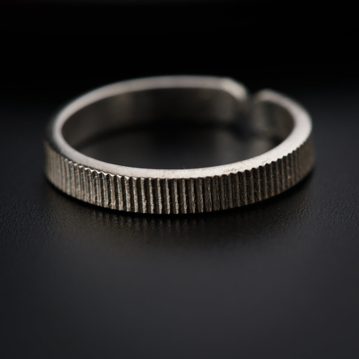 a close up of a ring on a black surface