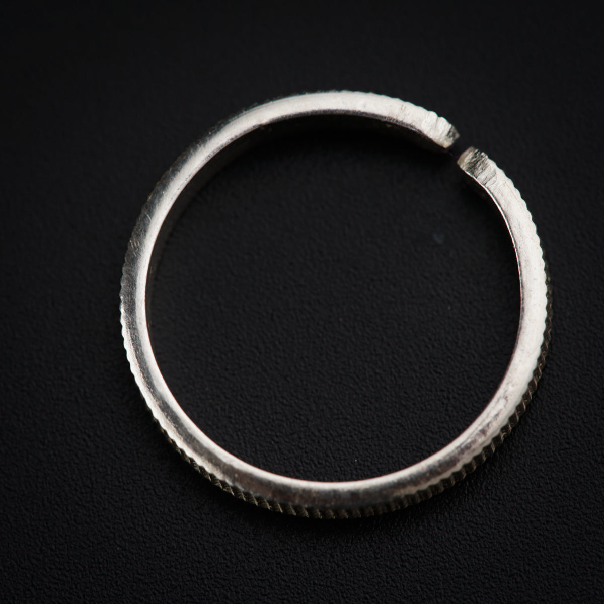 a close up of a ring on a black surface