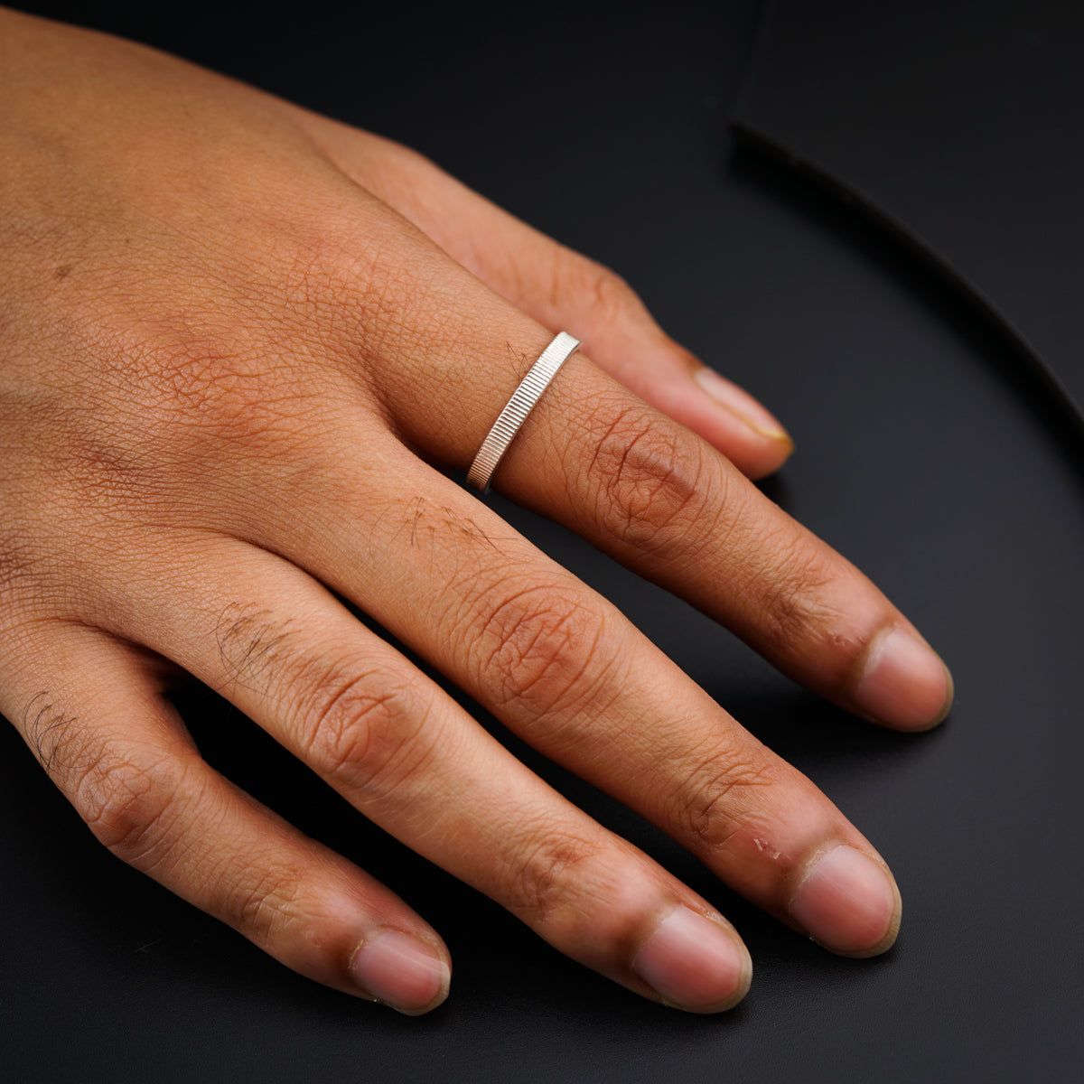 a person's hand with a ring on it