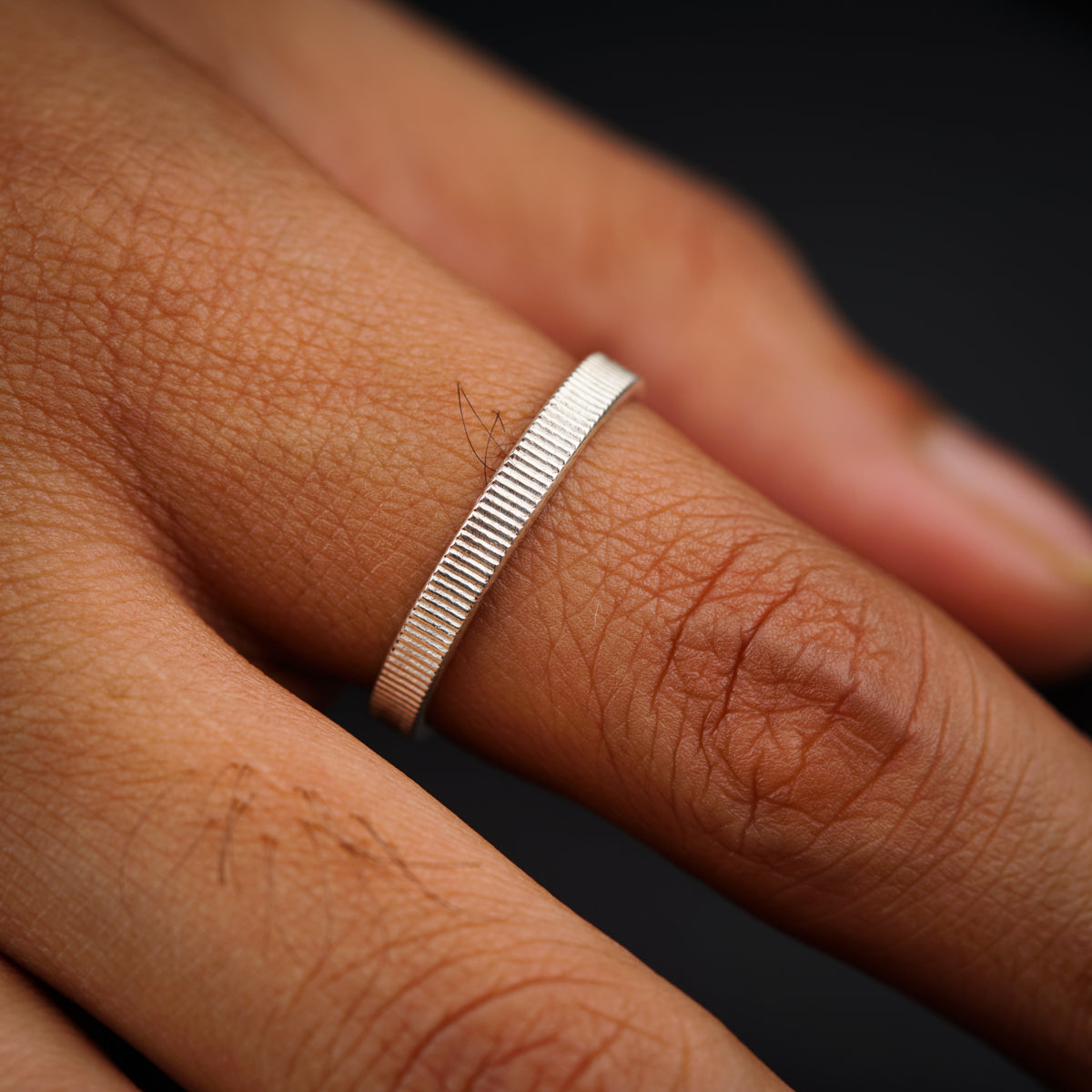 a close up of a person's hand with a ring on it