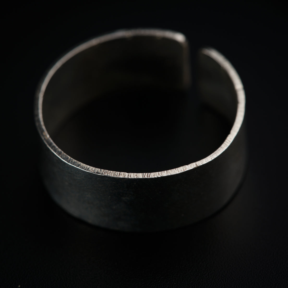 a close up of a metal object on a black surface