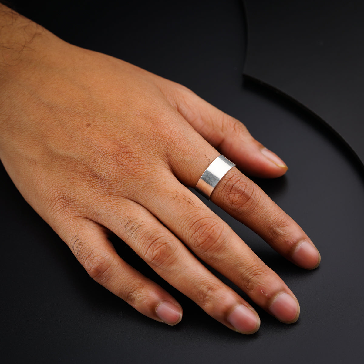 a person's hand with a ring on it