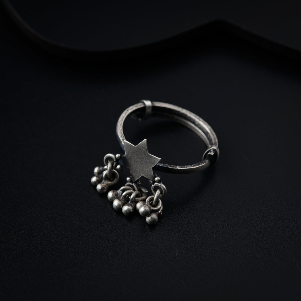 a silver ring with a star on top of it