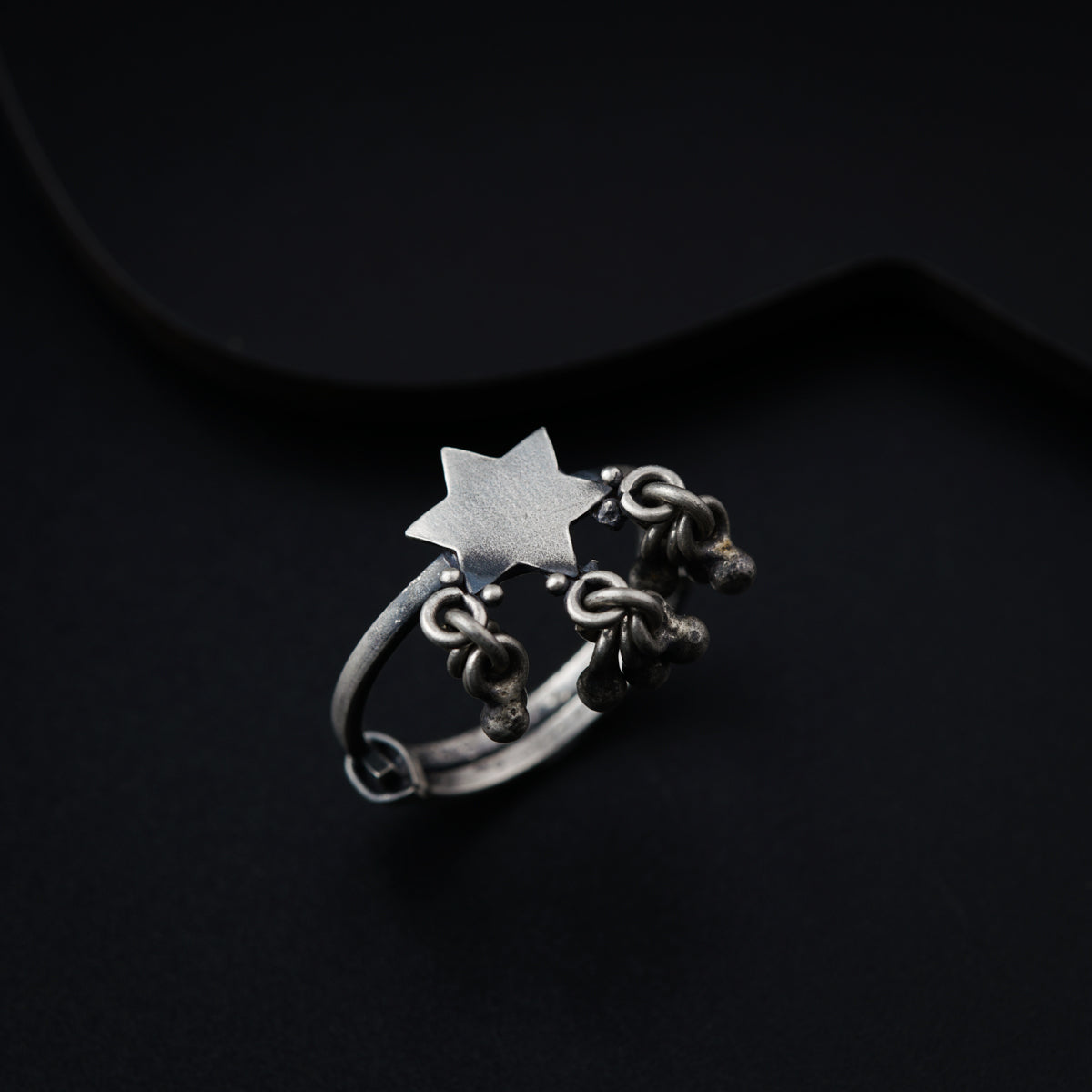 a silver ring with a star on it
