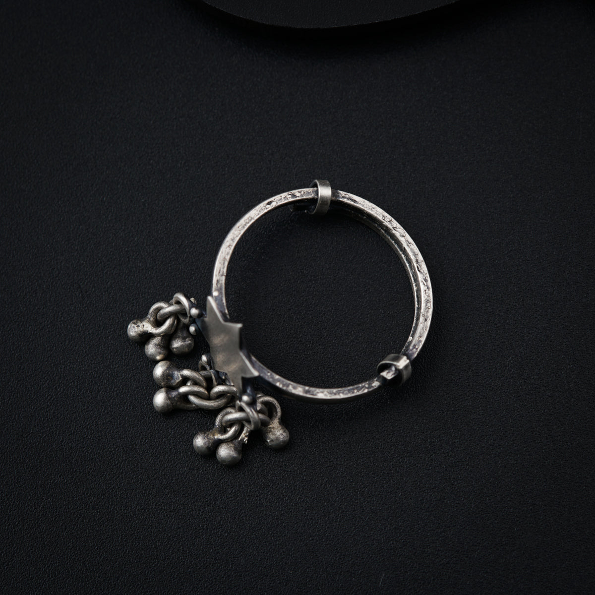a close up of a metal object on a black surface