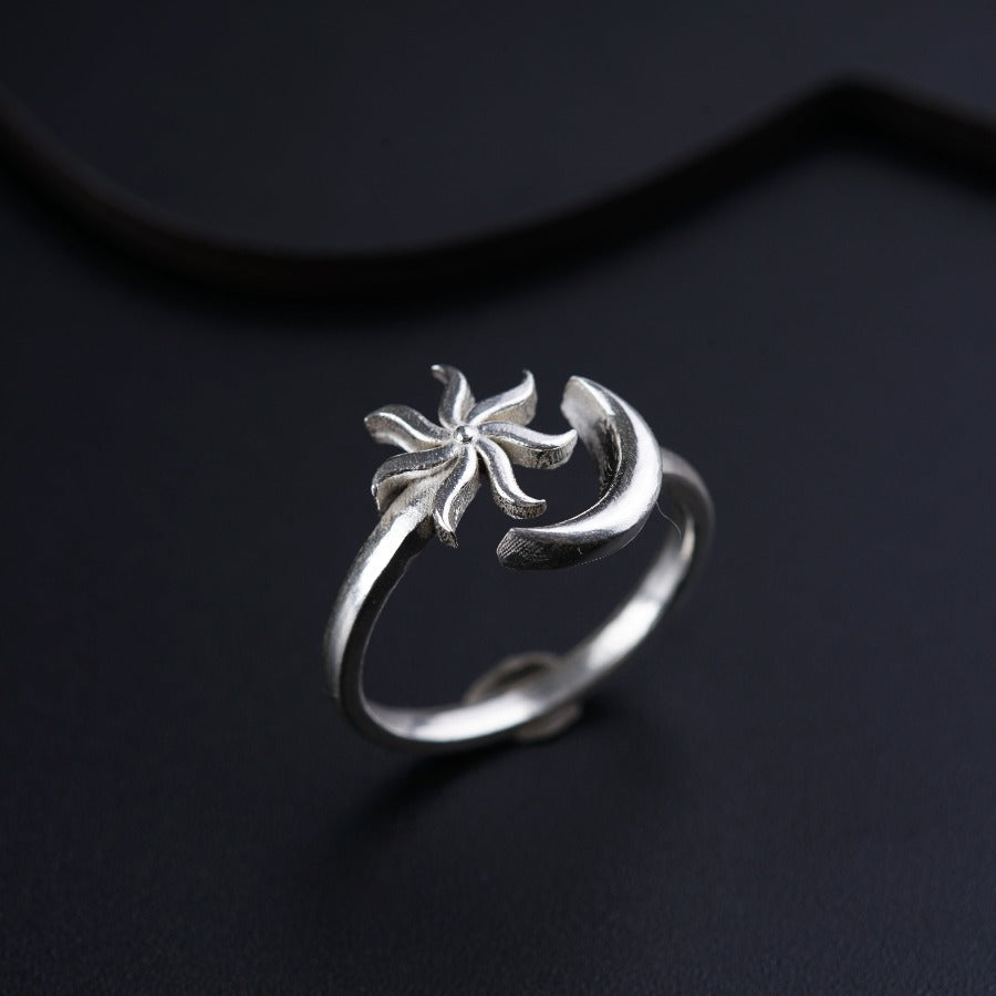 a silver ring with a flower on it