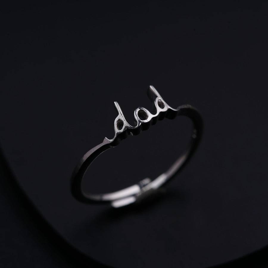 a silver ring with the word bad written on it