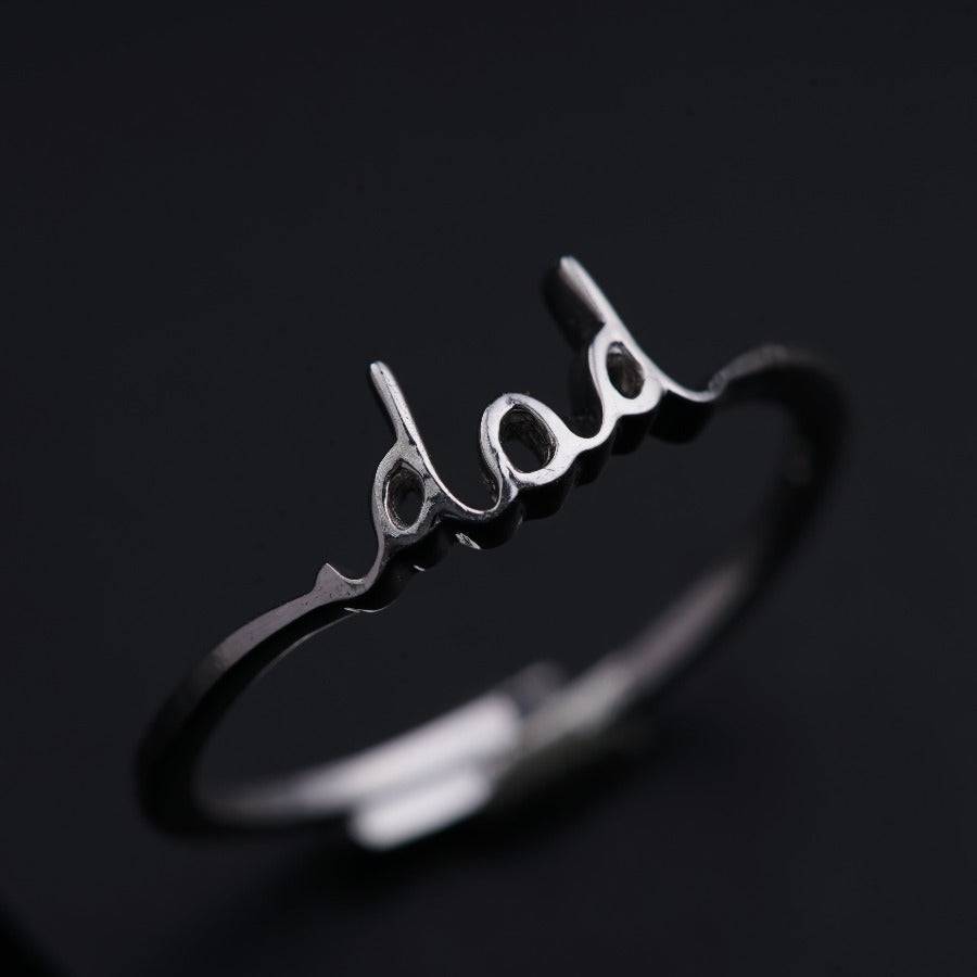 a silver ring with the word boo on it