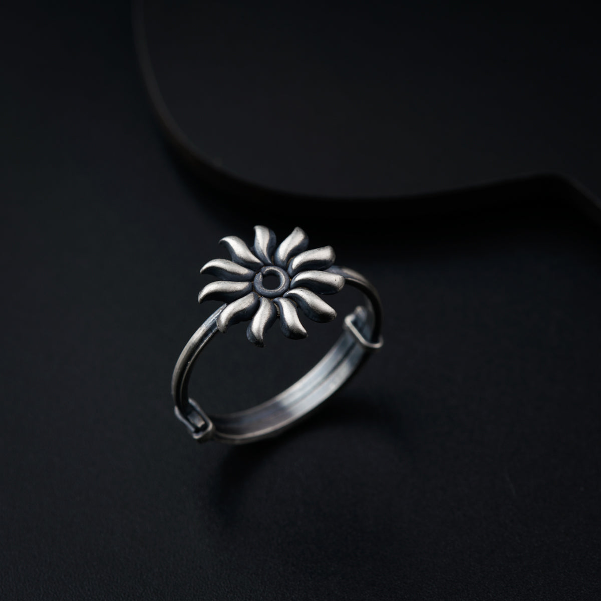 a silver ring with a flower on it