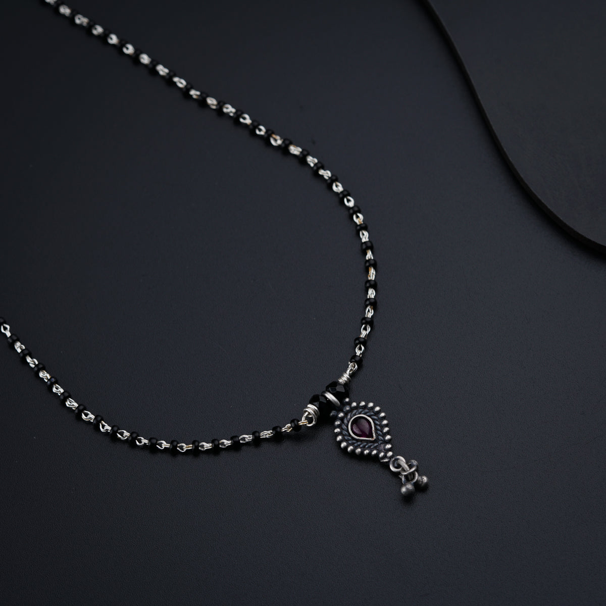 a necklace with a heart and a cross on it