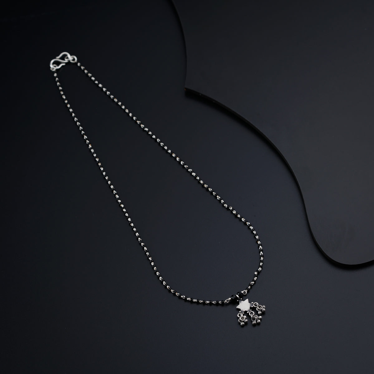 a necklace with a heart and a cross on it