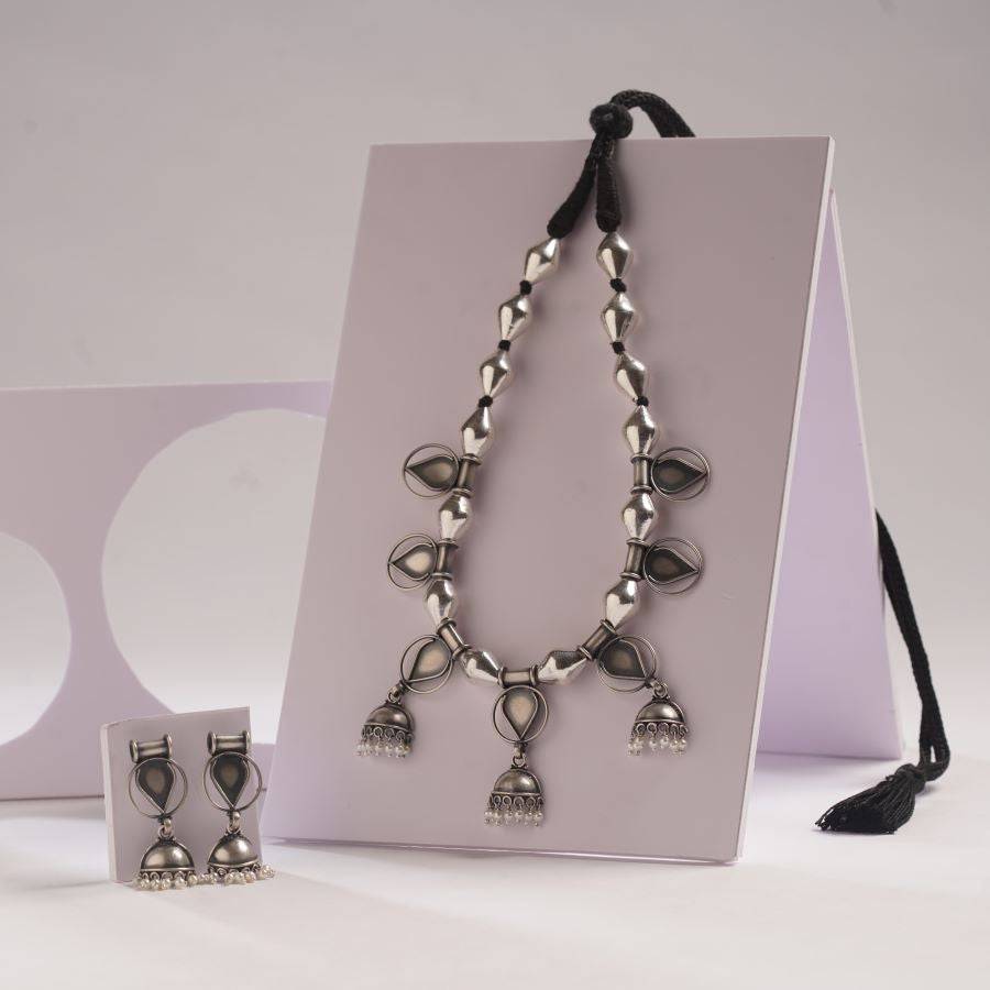a necklace and earring set sitting on a table