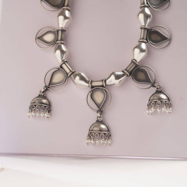 a close up of a necklace on a table